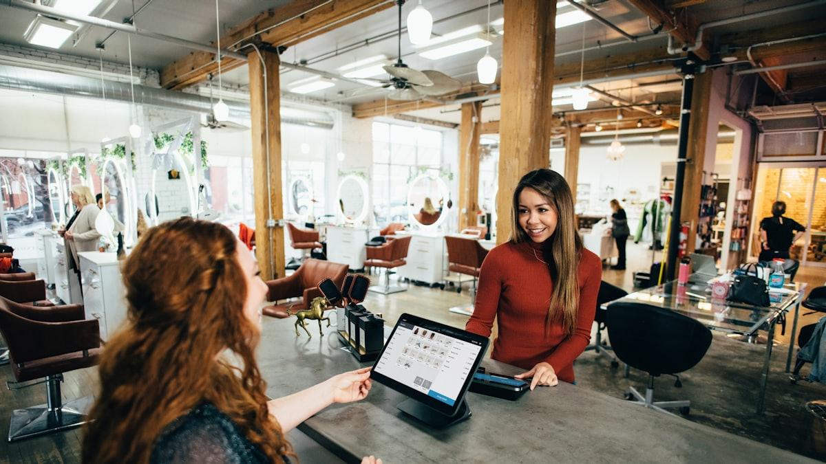 A local business owner serving a customer at the counter