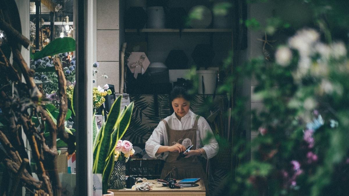 A florist working in their small shop