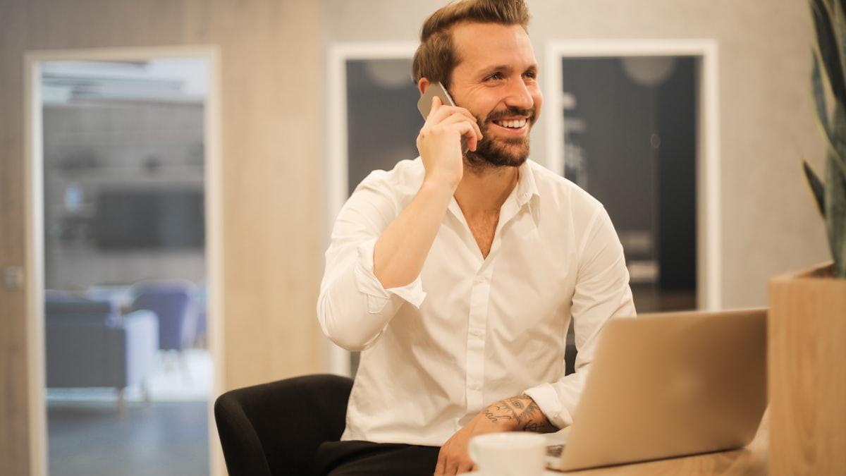 A happy customer smiling while on the phone